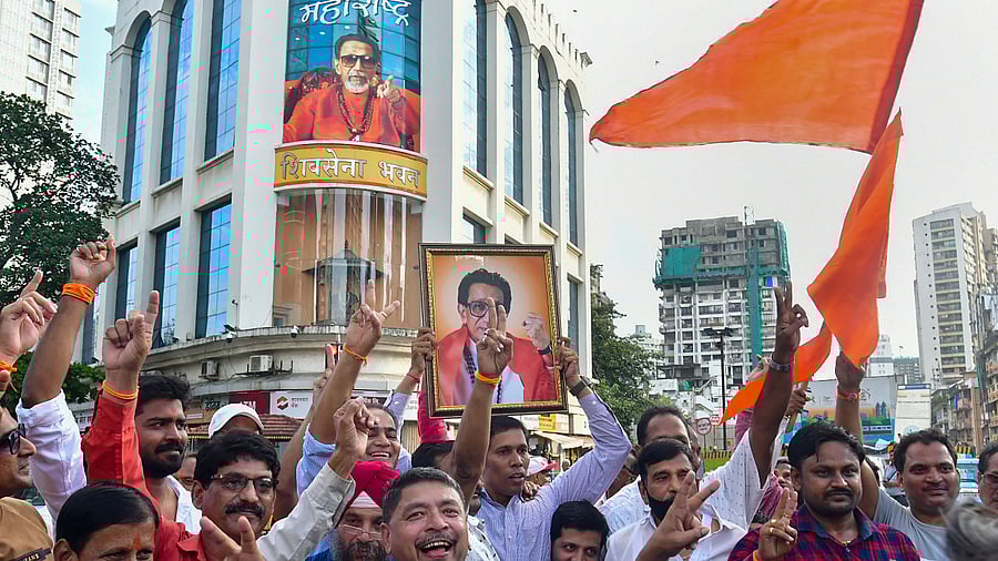 Shiv Sena party activists celebrate after the High Court directed the BMC to allow the Shiv Sena faction led by Uddhav Thackeray to hold a Dussehra gathering at Shivaji Park. Credit: PTI Photo