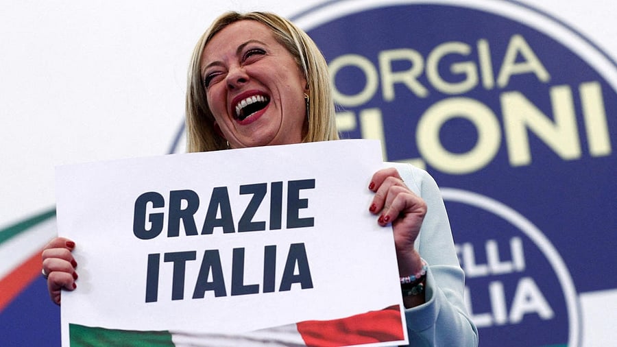 Leader of Brothers of Italy Giorgia Meloni holds a sign at the party's election night headquarters, in Rome. Credit: Reuters photo