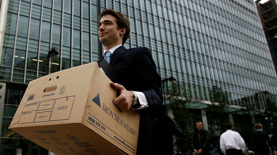 A worker carries a box out of the U.S. investment bank Lehman Brothers offices in the Canary Wharf district of London in this September 15, 2008. Credit: Reuters File Photo