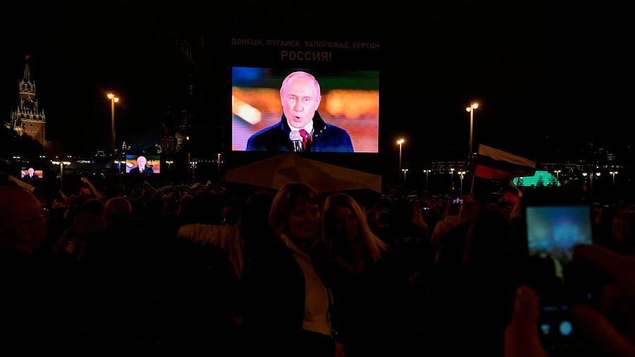 Russian President Vladimir Putin is seen on a screen as he addresses a rally and a concert marking the annexation of four regions of Ukraine Russian troops occupy. Credit: AFP Photo
