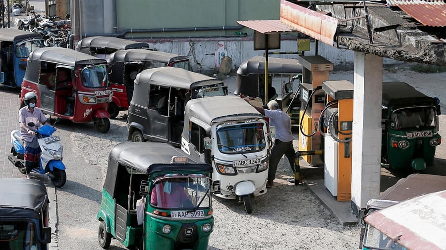 Three wheeler drivers wait in line to top up their tanks at a Ceylon Petroleum Corporation fuel station in Colombo, Sri Lanka February 21, 2022. Credit: Reuters Photo