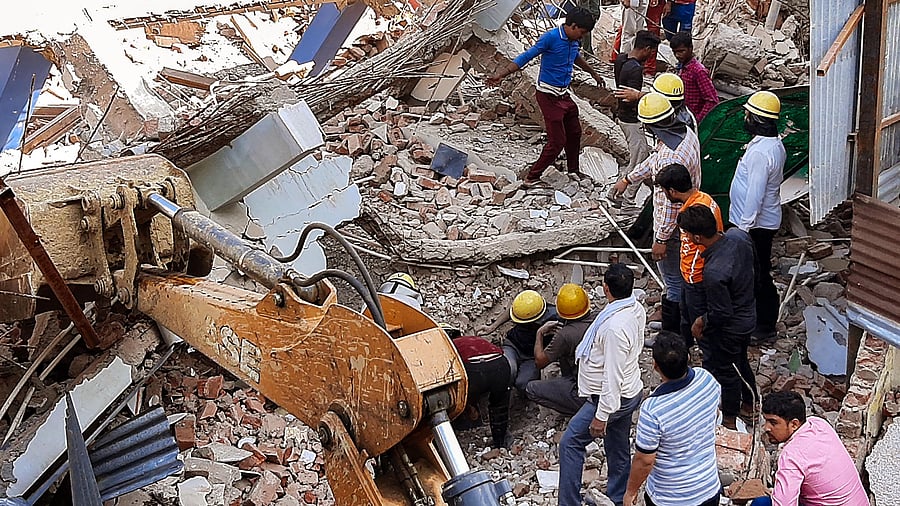 Rescue operation under way after a portion of a building, that was being demolished, collapsed, in Gurugram. Credit: PTI Photo