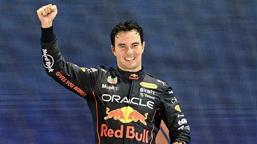 Winner Red Bull Racing's Mexican driver Sergio Perez celebrates on the podium after the Formula One Singapore Grand Prix night race at the Marina Bay Street Circuit in Singapore on October 2, 2022. Credit: AFP Photo