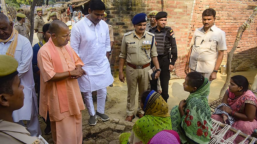 UP CM Yogi Adityanath meets family members of victims of last night's road accidents, at a village in Kanpur district, Sunday, Oct. 2, 2022. Credit: PTI Photo