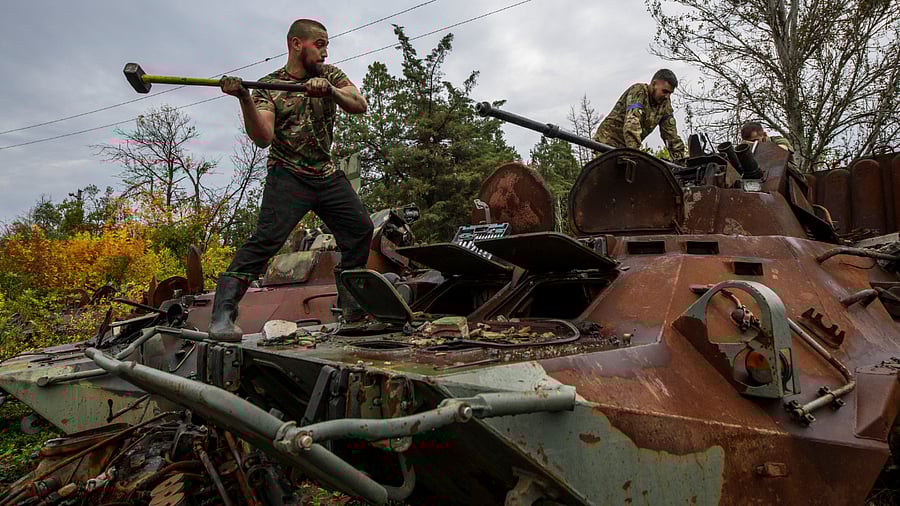 Ukrainian service member dismount a cannon from a captured Russian armoured personnel carrier, amid Russia's attack on Ukraine, near the town of Izium in Kharkiv region. Credit: Reuters Photo