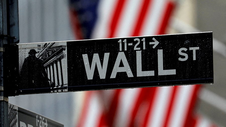 Raindrops hang on a sign for Wall Street outside the New York Stock Exchange in Manhattan in New York City, October 26, 2020. Credit: Reuters File Photo