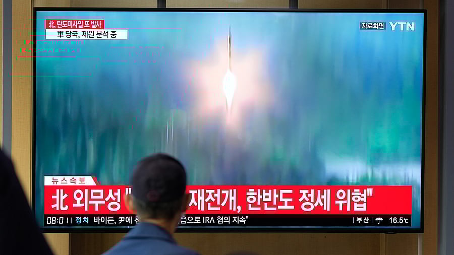 A TV screen showing a news program reporting about North Korea's missile launch with file footage. Credit: AP/ PTI Photo