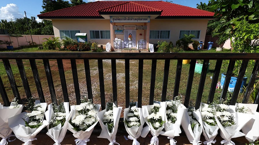 Some bowed their heads in prayer, some hugged each other in consolation as they laid the blooms on the steps of the low, yellow-walled building, tributes to 22 young lives cut short. Credit: Reuters Photo