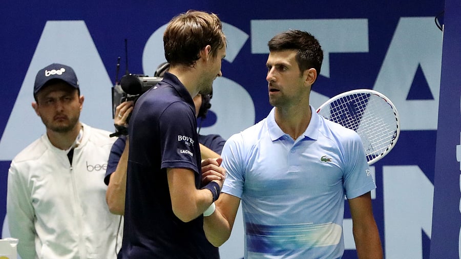 Serbia's Novak Djokovic and Russia's Daniil Medvedev shake hands after their semi final match, October 8, 2022. Credit: Reuters Photo