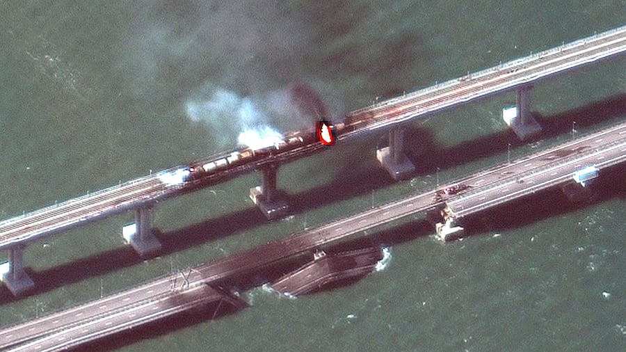 This handout satellite image taken and released by Maxar Technologies on October 8, 2022, shows smoke billowing from a fire on the Crimea Bridge. Credit: AFP Photo