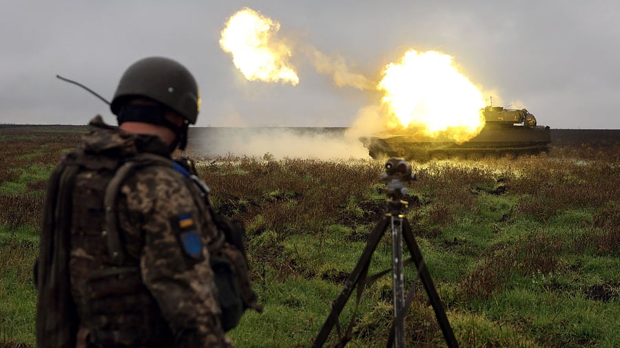 A Ukrainian soldier stands as a 2S1 Gvozdika self-propelled howitzer fires a shell on the front line in Donetsk region on October 10, 2022. Credit: AFP Photo