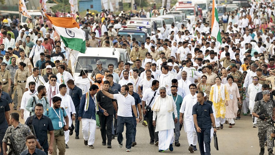 Congress leader Rahul Gandhi waves the national flag as he he walks with supporters during the party's 'Bharat Jodo Yatra', in Chitradurga district, Karnataka, Wednesday, Oct. 12, 2022. Credit: PTI Photo