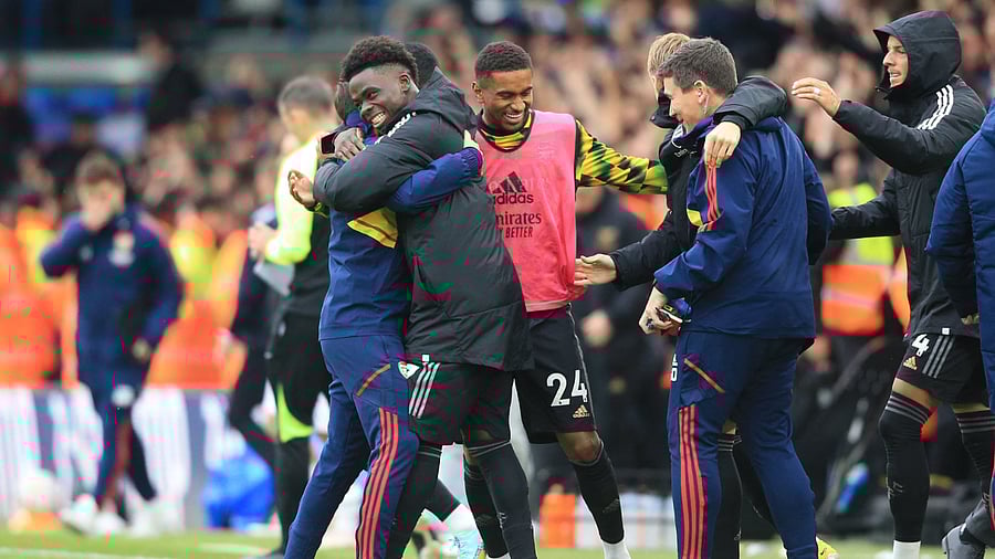 Arsenal's English midfielder Bukayo Saka (C) celebrates with teammates on the pitch after the English Premier League football match between Leeds United and Arsenal at Elland Road in Leeds, northern England. Credit: AFP Photo
