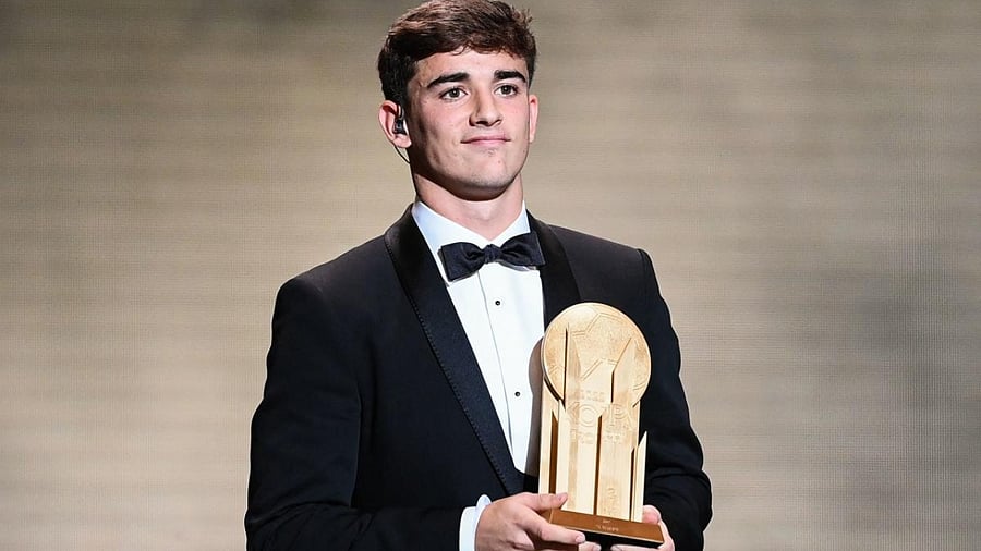 Barcelona's Spanish midfielder Gavi poses with the Kopa Trophy for best under-21 player during the 2022 Ballon d'Or France Football award ceremony. Credit: AFP Photo