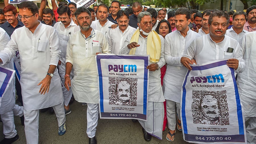 Karnataka Congress leaders hold posters with QR code and the phrase 'PayCM', during a protest against the state government on the issue of alleged corruption, in Bengaluru, Friday, Sept. 23, 2022. Credit: PTI File Photo