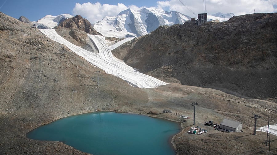 Snow from the last winter season is covered with blankets on a slope beside the top station of a cablecar at Diavolezza ski area near the Alpine resort of Pontresina, Switzerland July 21, 2022. Credit: Reuters Photo