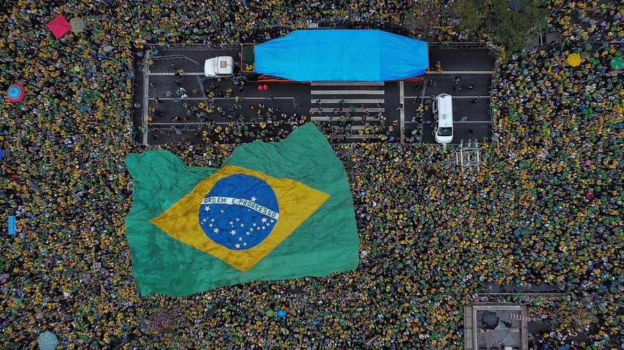 In this file photo taken on September 07, 2022, supporters of Brazilian President Jair Bolsonaro display a huge national flag as they celebrate Brazil's 200th anniversary of independence, along Paulista Avenue in Sao Paulo, Brazil. Credit: AFP Photo