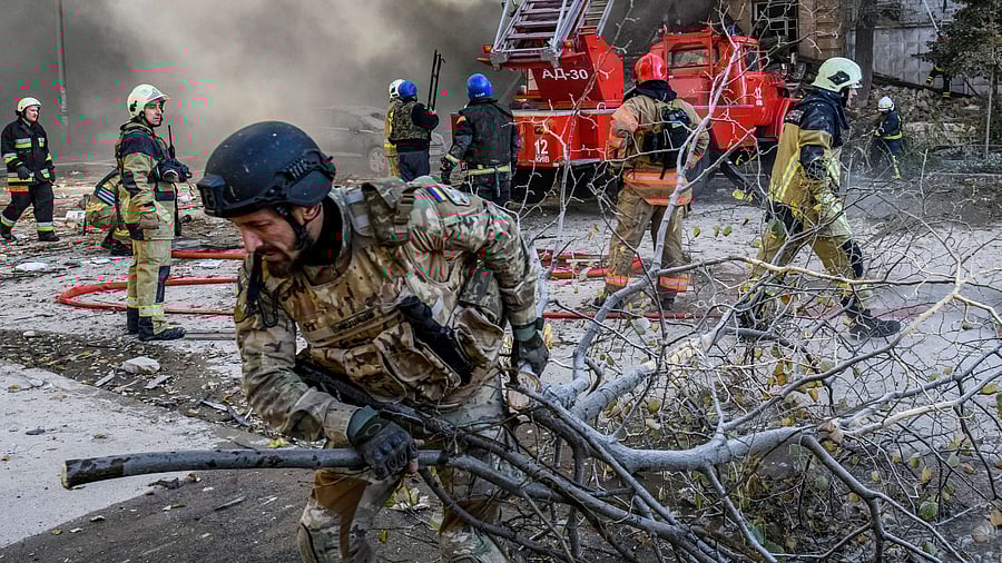Firefighters help a local woman evacuate from a residential building destroyed by a Russian drone strike, Credit: Reuters File Photo