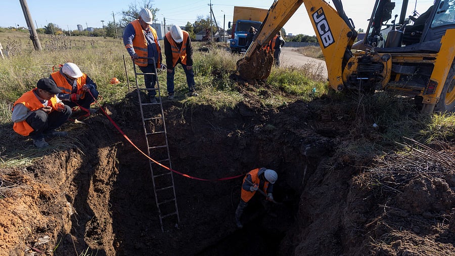 Employees of a municipal water supply company repair damaged water pipes, amid Russia's attack on Ukraine, in Mykolaiv, Ukraine. Credit: Reuters Photo