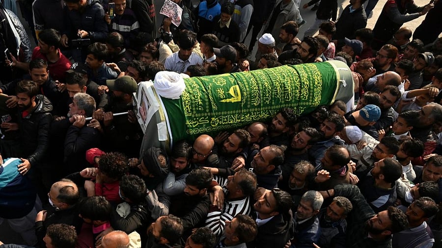 Kashmiri Muslims gather along a street during the funeral procession of top Shiite cleric and veteran Kashmiri seperatist leader Moulvi Abbas Ansari