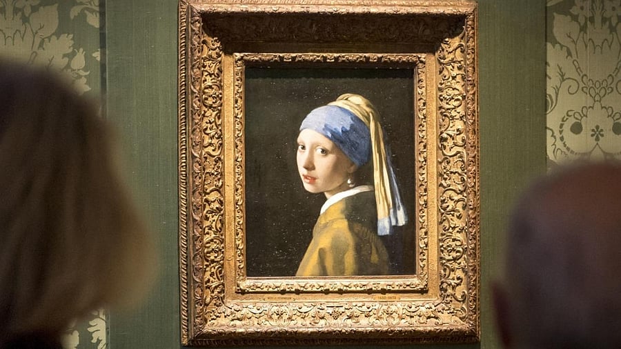 Visitors looks at the Johannes Vermeer's painting 'Girl with a Pearl Earring' at the Mauritshuis museum in The Hague, 27 October 2022. Credit: AFP Photo