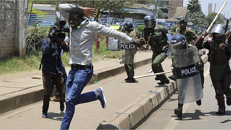 A protestor attempts to flee Kenyan police during the 2017 post-election unrest. Credit: AFP Photo