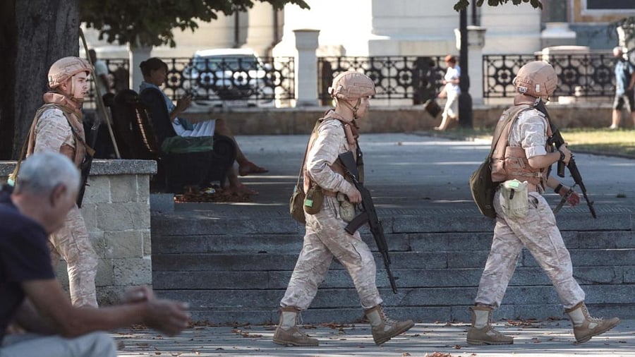 Russian Navy troops patrol in front of a headquarter of Russia's Black Sea Fleet in Sevastopol, in Crimea. Credit: AFP File Photo
