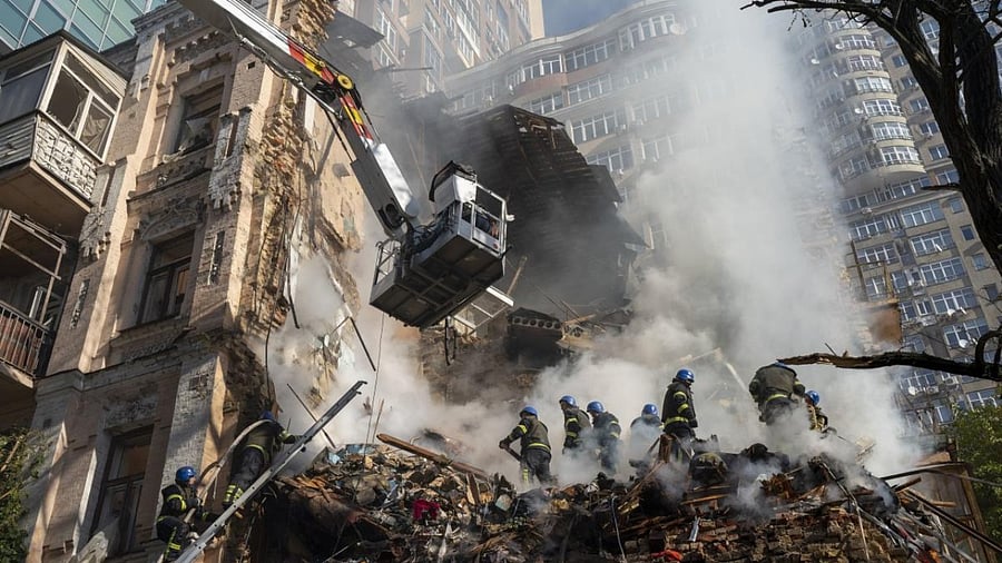 Firefighters work after a drone attack on buildings in Kyiv. Credit: AP File Photo