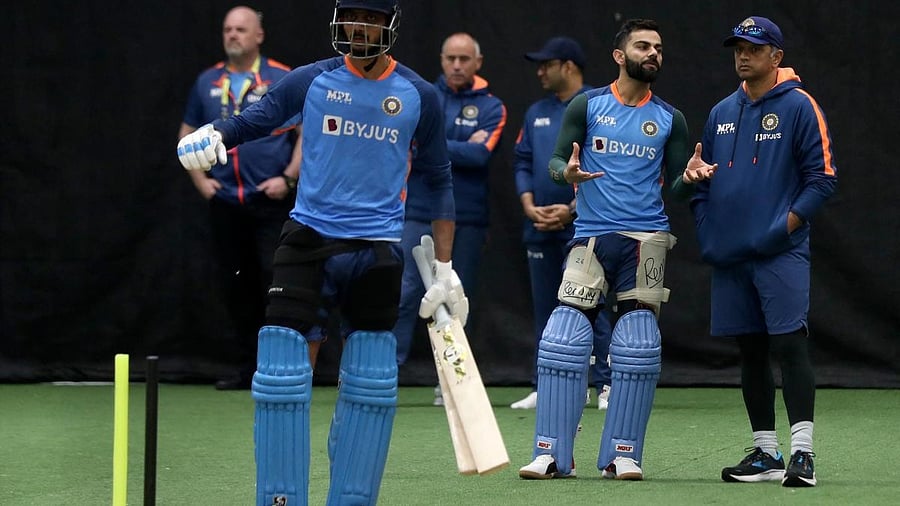 India's Virat Kohli (2nd L) talks to team coach Rahul Dravid (L) during net practice session ahead of the ICC men's Twenty20 World Cup 2022 cricket match India and Bangladesh. Credit: AFP Photo