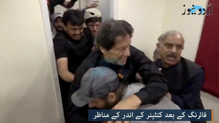 Former Pakistani Prime Minister Imran Khan is helped after he was shot in the shin in Wazirabad. Credit: Urdu Media via Reuters Photo