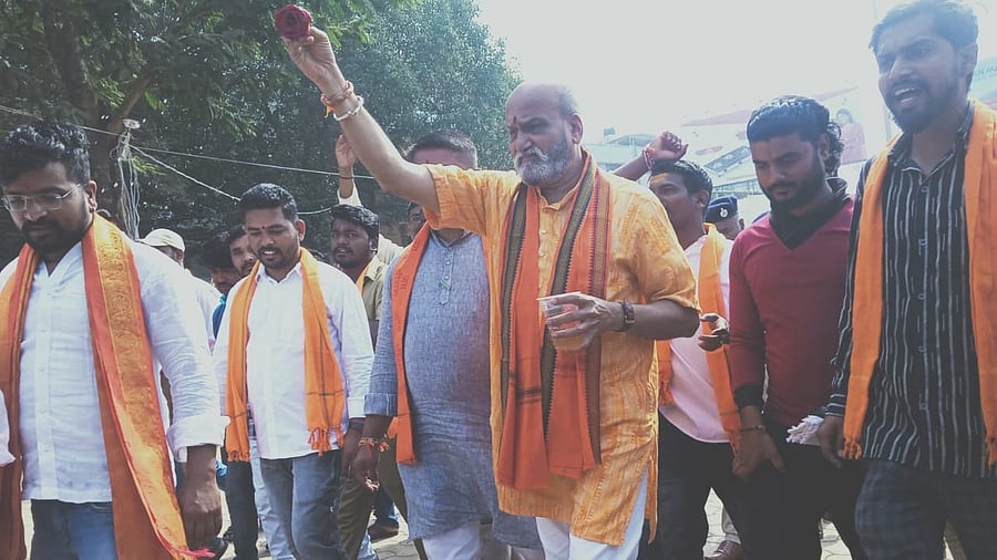 Sri Ram Sena chief Pramod Muthalik sprinkles goumutra at a portion of Idgah Maidan in Hubballi on Friday, before attending Kanakadasa Jayanti at the ground. Credit: DH Photo