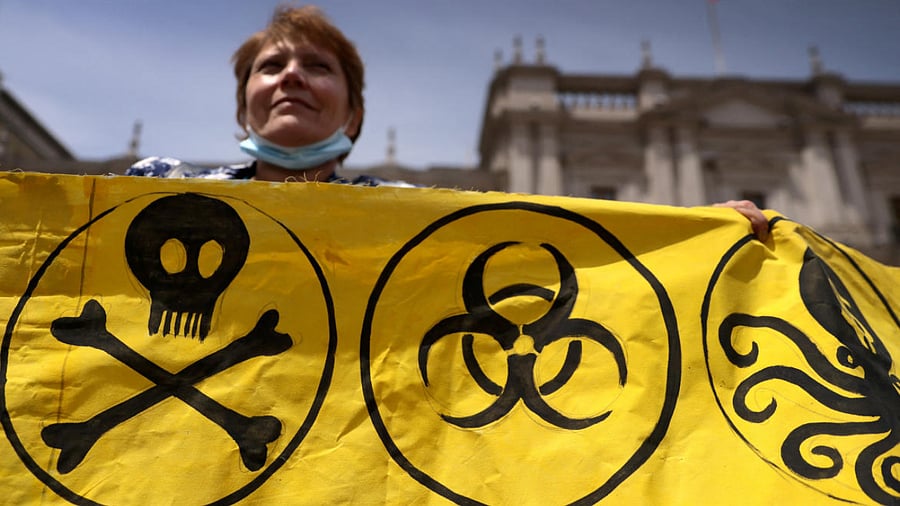 An environment activist holds a sign during a rally to protest for climate justice, human rights and against COP27 climate summit which is being held in Egypt. Credit: Reuters Photo