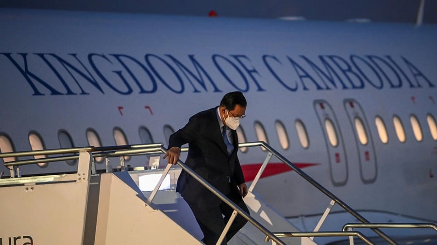 Cambodian Prime Minister Hun Sen walks down the stairs of the presidential plane on his arrival at Ngurah Rai International Airport ahead of the G20 Summit in Bali, Indonesia. Credit: Reuters Photo