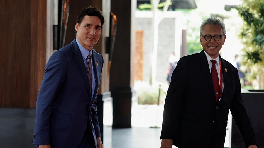 Canada's Prime Minister Justin Trudeau and Andy Rachmianto, Indonesia's Director-General for Protocol and Consular Affairs, arrive for the G20 leaders' summit in Nusa Dua, Bali, Indonesia, November 15, 2022. Credit: Reuters Photo