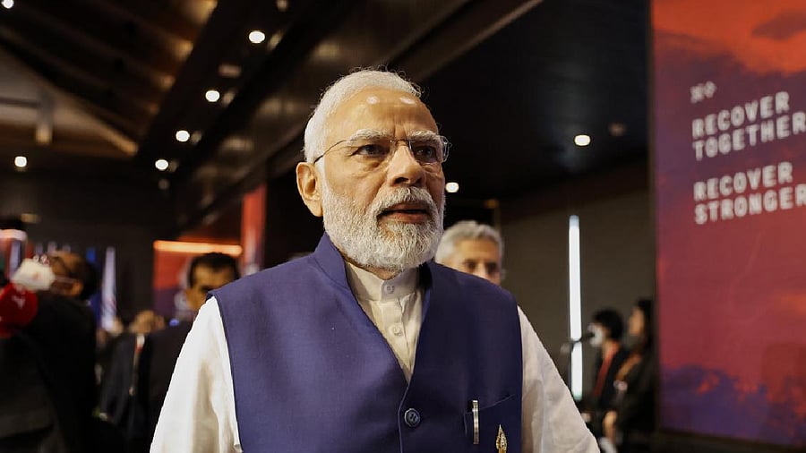 India's PM Narendra Modi walks during the handover ceremony at the G20 Leaders' Summit. Credit: AP Photo