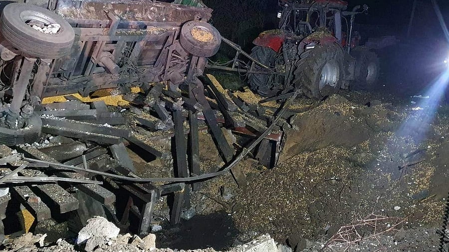 A damaged vehicle lies next to a crater formed at the site of an explosion in Przewodow, a village in eastern Poland near the border with Ukraine. Credit: Reuters Photo