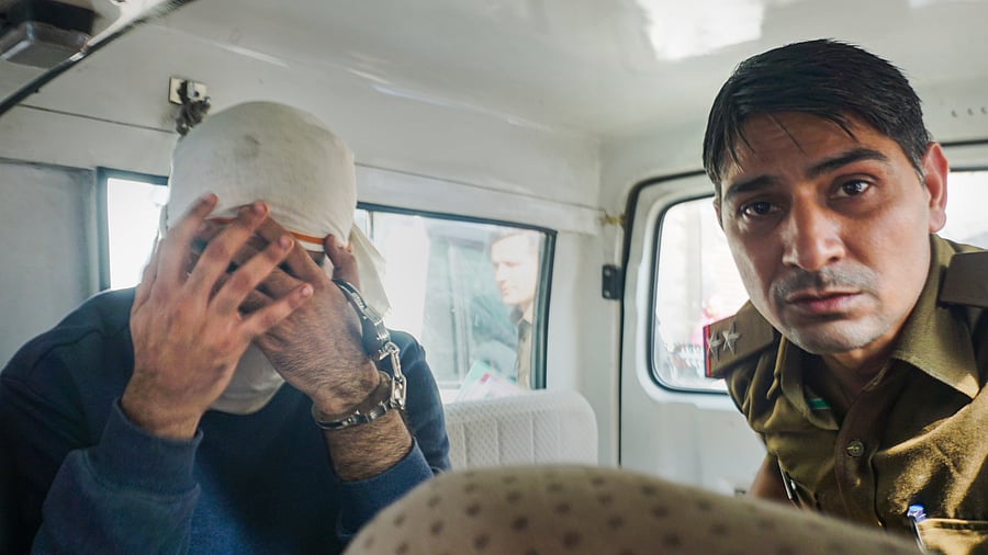 Aaftab Amin Poonawala, accused to have murdered his live-in partner Shraddha Walkar, being brought to the Mehrauli forest area. Credit: PTI Photo