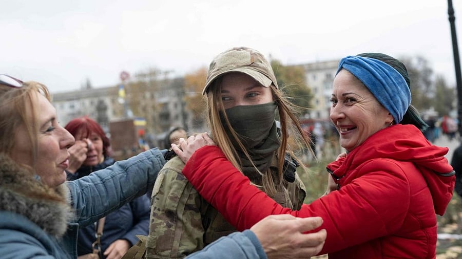 Women greet a Ukrainian soldier as local residents gather to celebrate the liberation of Kherson, on November 13, 2022, amid Russia's invasion of Ukraine. Credit: AFP Photo