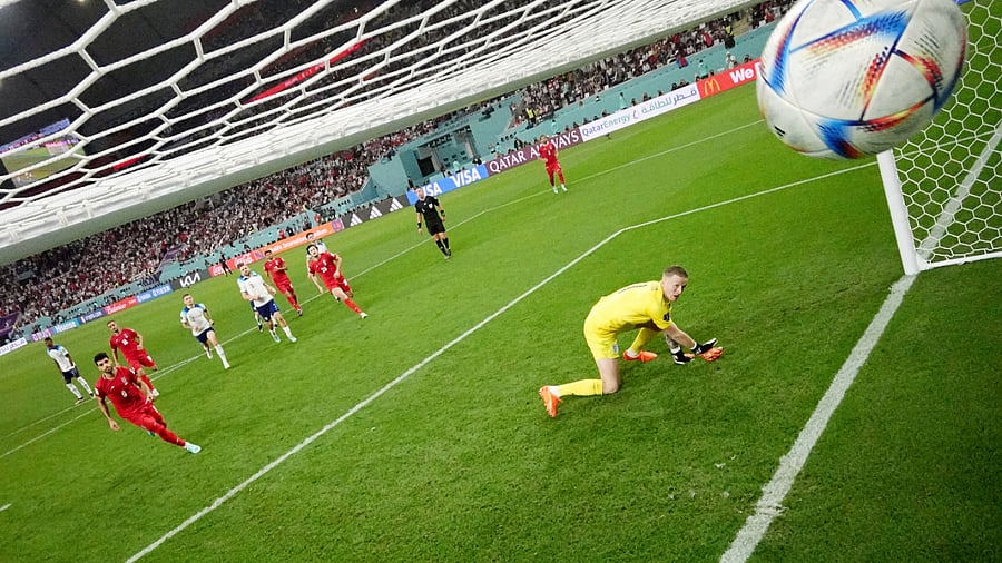 Iran's Mehdi Taremi scores their second goal from the penalty spot past England's Jordan. Credit: Reuters/Hannah Mckay Photo