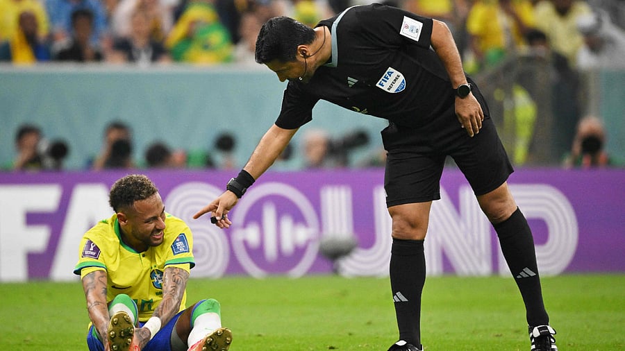 Iranian referee Alireza Faghani (R) gestures to Brazil's forward #10 Neymar during the Qatar 2022 World Cup Group G football match between Brazil and Serbia. Credit: AFP Photo