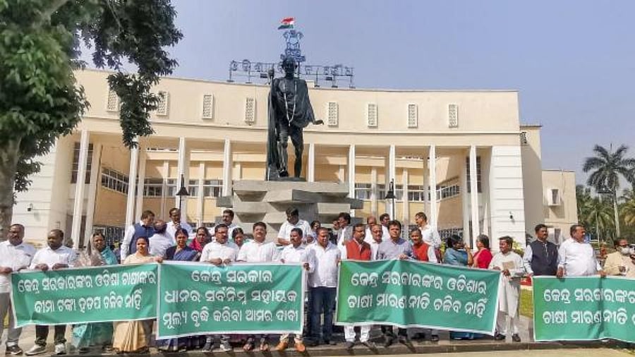 BJD MLAs stage a protest near Mahatma Gandhi statue during the winter session of Odisha Assembly. Credit: PTI Photo