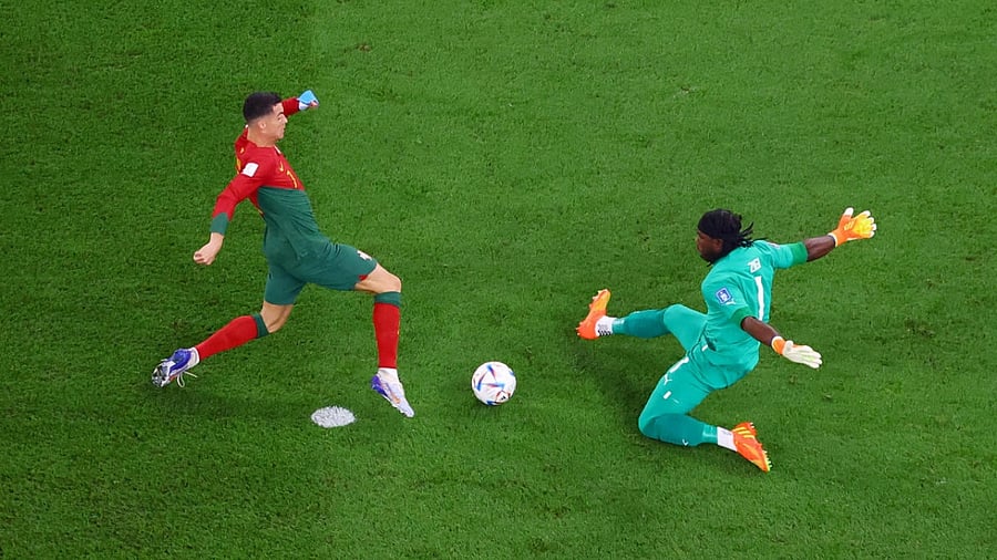Portugal's Cristiano Ronaldo in action with Ghana's Lawrence Ati-Zigi. Credit: Reuters Photo
