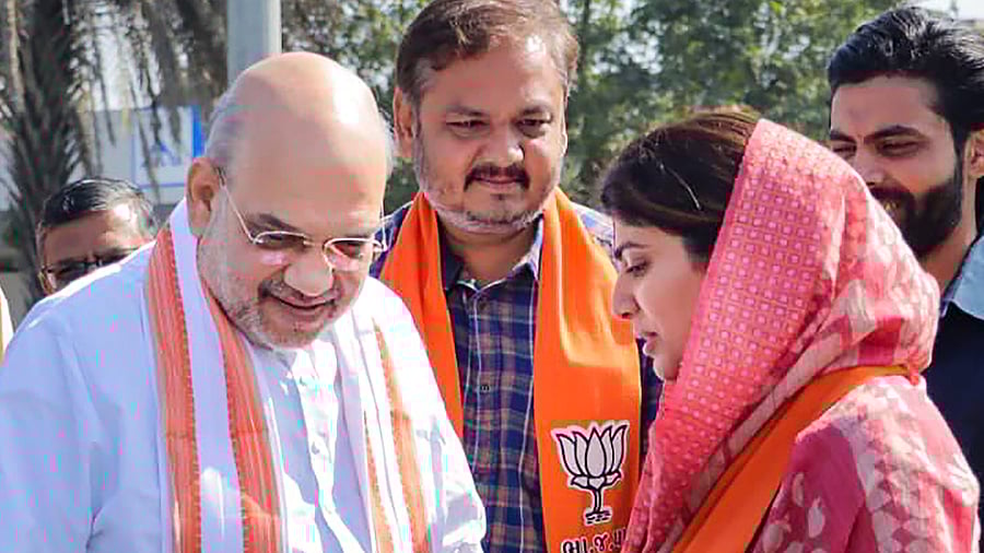 Union Home Minister Amit Shah meets BJP candidate for Gujarat elections Rivaba Jadeja and her husband & cricketer Ravindra Jadeja at Jamnagar Airport. Credit: PTI Photo