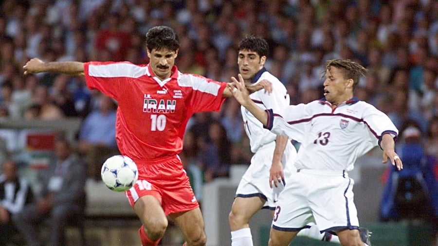 In this file photo taken on June 21, 1998, Iranian forward Ali Daei (L) fights for the ball with US midfielder Cobi Jones (R) during the France 1998 World Cup. Credit: AFP Photo
