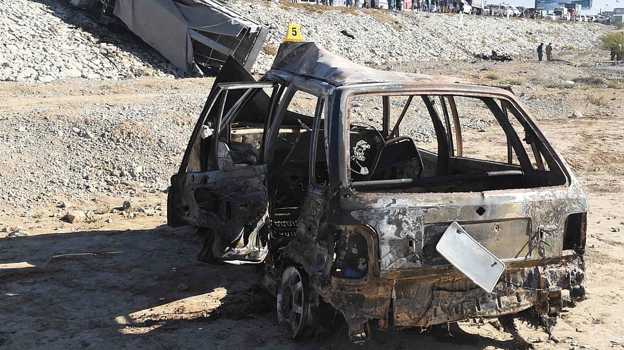 Scraps of metal littered the scene, with another vehicle -- presumed to have been used in the attack -- reduced to a charred tangle. Credit: AFP Photo