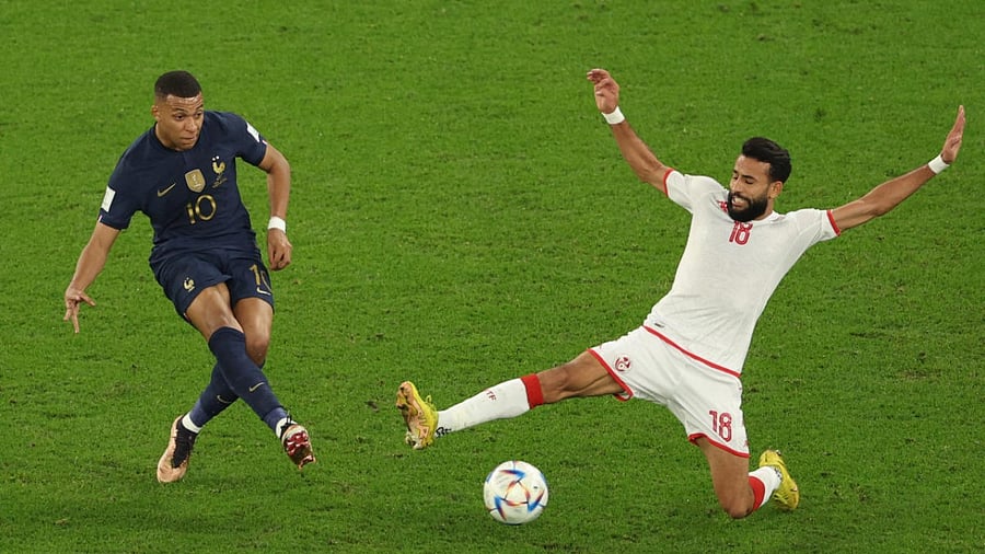Tunisia's midfielder #18 Ghailene Chaalali tries to block a shot by France's forward #10 Kylian Mbappe. Credit: AFP Photo