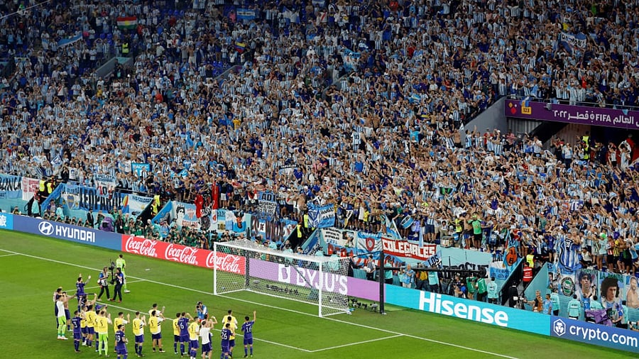 Argentina players celebrate qualifying for the knockout stages. Credit: Reuters Photo