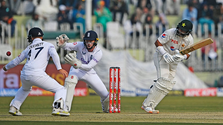 Pakistan's Imam-ul-Haq (R) plays a shot as England's wicketkeeper Ollie Pope (C) watches during the second day of the first cricket Test match between Pakistan and England at the Rawalpindi Cricket Stadium, in Rawalpindi. Credit: AFP Photo