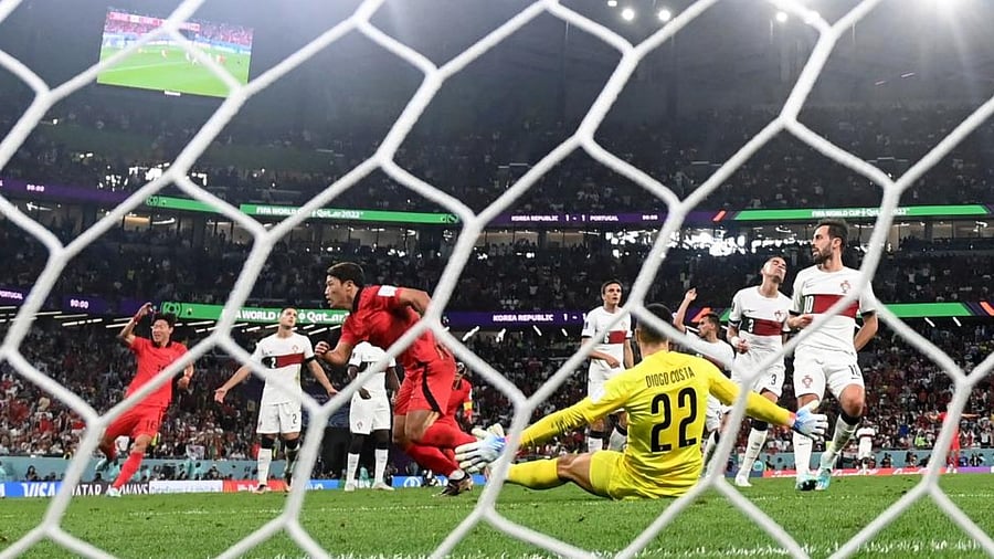 South Korea's midfielder Hwang Hee-chan (L) scores his team's second goal during the Qatar 2022 World Cup Group H football match between South Korea and Portugal at the Education City Stadium in Al-Rayyan, west of Doha on December 2, 2022. Credit: AFP Photo