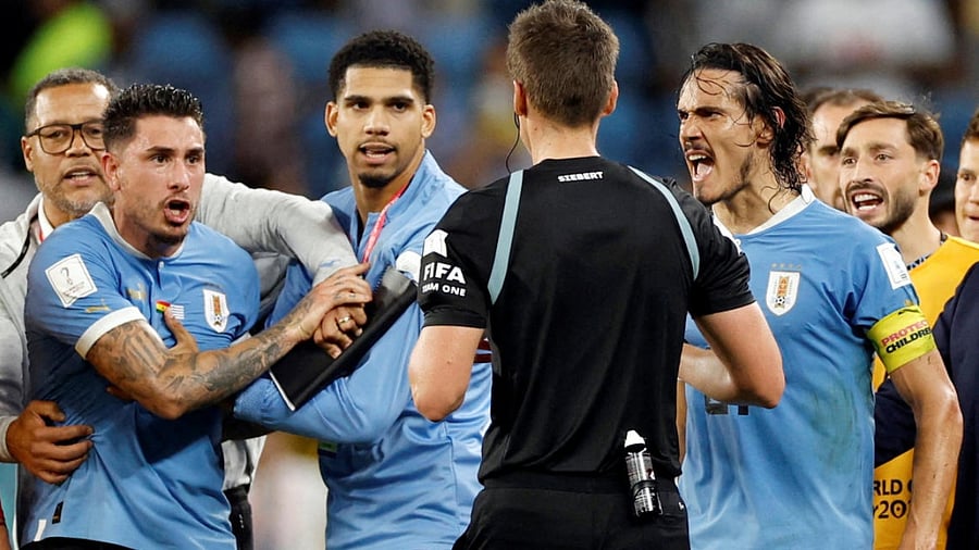 Uruguay's Jose Maria Gimenez and Edinson Cavani remonstrate with referee Daniel Siebert after the match with Ghana. Credit: Reuters Photo